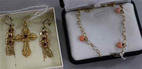 A yellow metal and ruby cross pendant (tests as 14ct), a similar pair of garnet-set earrings and a 9ct gold and coral necklace